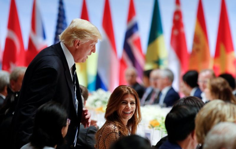 US President Donald Trump and the wife of the Argentinia's President Juliana Awada attend the banquet after a concert of the participants of the G20 summit and their spouses at the Elbphilharmonie concert hall during the G20 Summit in Hamburg, Germany, on July 7, 2017. 
Leaders of the world's top economies will gather from July 7 to 8, 2017 in Germany for likely the stormiest G20 summit in years, with disagreements ranging from wars to climate change and global trade. / AFP PHOTO / POOL / AXEL SCHMIDT