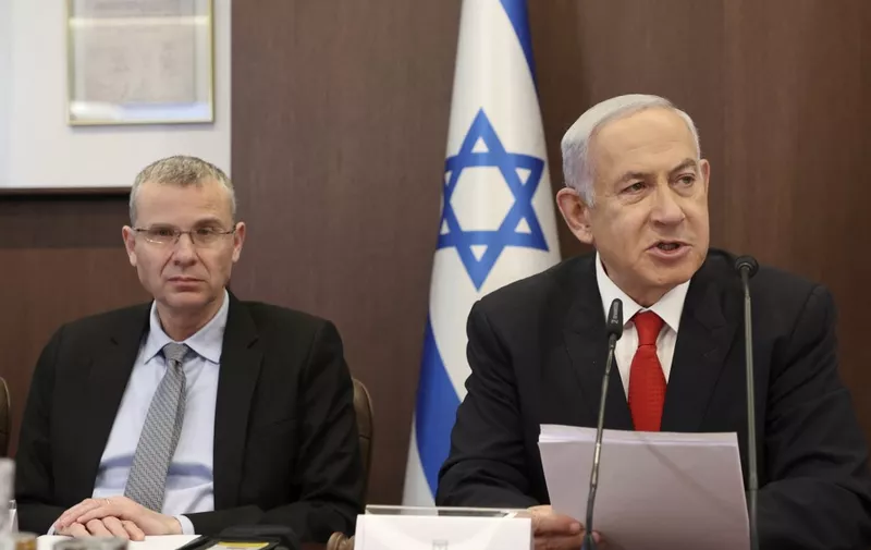 Israeli Prime Minister Benjamin Netanyahu (R) chairs the weekly cabinet meeting, flanked by Justice Minister Yariv Levin, at the prime minister's office in Jerusalem on March 5, 2023. (Photo by GIL COHEN-MAGEN / POOL / AFP)