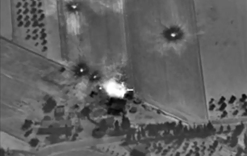 A video grab made on October 1, 2015, shows an image taken footage made available on the Russian Defence Ministry's official website, purporting to show an airstrike in Syria. President Vladimir Putin on October 1 dismissed claims that Russian air strikes had killed civilians in Syria as "information warfare" but said Moscow would look into those reports. AFP PHOTO / RUSSIAN DEFENCE MINISTRY
	 RESTRICTED TO EDITORIAL USE - MANDATORY CREDIT " AFP PHOTO / RUSSIAN DEFENCE MINISTRY" - NO MARKETING NO ADVERTISING CAMPAIGNS - DISTRIBUTED AS A SERVICE TO CLIENTS 