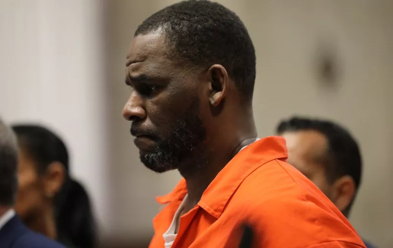(FILES) In this file photo taken on September 17, 2019 singer R. Kelly appears during a hearing at the Leighton Criminal Courthouse in Chicago, Illinois. - A US federal judge on June 29, 2022 was set to sentence disgraced R&amp;B singer R. Kelly nearly a year after he was convicted of leading a decades-long effort to recruit and trap teenagers and women for sex. Prosecutors have urged the court to put the "I Believe I Can Fly" artist behind bars for at least 25 years, saying he still "poses a serious danger to the public." (Photo by Antonio PEREZ / POOL / AFP)