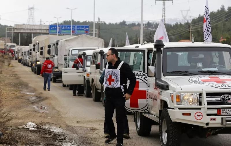 A convoy of aid from the International Committee of the Red Cross (ICRC) waits on the outskirts of the besieged rebel-held Syrian town of Madaya, on January 11, 2016. 
Dozens of aid trucks headed to Madaya, where more than two dozen people are reported to have starved to death, after an outpouring of international concern and condemnation over the dire conditions in the town, where some 42,000 people are living under a government siege.

 / AFP / LOUAI BESHARA