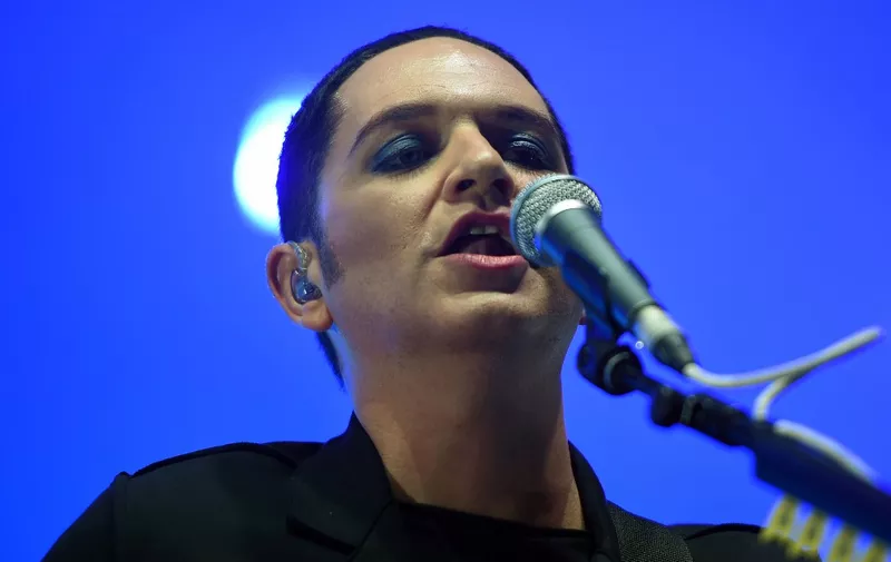 (FILES) British singer Brian Molko of the Placebo's band performs on stage during the 41st edition of "Le Printemps de Bourges" rock and pop music festival in Bourges, on April 19, 2017. Italian prosecutors have opened an investigation against the frontman of British group Placebo, who during a concert called Prime Minister Giorgia Meloni "racist" and "fascist", local media reported July 18, 2023. Lead singer Brian Molko, 50, was performing last week with the band at the Sonic Park festival in Stupinigi outside Turin when he hurled insults from the stage about Italy's premier. (Photo by GUILLAUME SOUVANT / AFP)