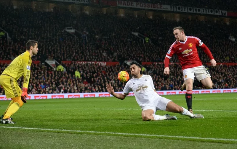 Manchester United's English striker Wayne Rooney (R) scores his team's second goal during the English Premier League football match between Manchester United and Swansea City at Old Trafford in Manchester, north west England, on January 2, 2016. AFP PHOTO / OLI SCARFF

RESTRICTED TO EDITORIAL USE. No use with unauthorized audio, video, data, fixture lists, club/league logos or 'live' services. Online in-match use limited to 75 images, no video emulation. No use in betting, games or single club/league/player publications. / AFP / OLI SCARFF