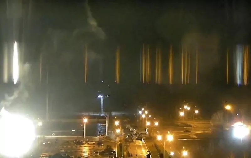 Image grab from a video feed from the Zaporizhzhia nuclear power plant in southeast Ukraine early on Friday March 4, 2022 shows shelling and smoke rising near a building at the plant compound during an attack by Russian forces. The assault renewed fears that the invasion could result in damage to one of Ukraine's 15 nuclear reactors and trigger another emergency like the 1986 Chernobyl accident, the world's worst nuclear disaster, which happened about 110 kilometers (65 miles) north Kyiv. The Zaporizhzhia plant is the largest in Europe. A fire broke out as a result of the shelling. Nuclear watchdog IAEA said so far no reactors are hit. (Zaporizhzhia Nuclear Authority/EYEPRESS) (Photo by EyePress News / EyePress via AFP)