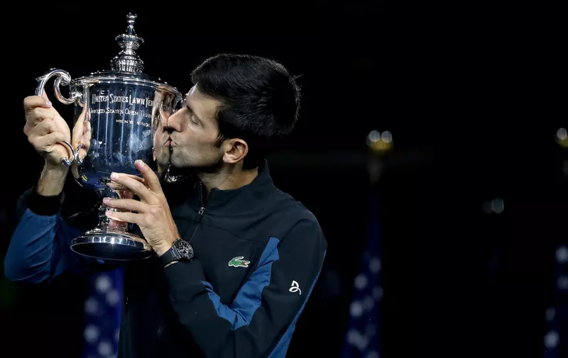 NEW YORK, NY - SEPTEMBER 09:  Novak Djokovic of Serbia kisses the trophy as he celebrates his win over Juan Martin Del Potro of Argentina during the men's final of the US Open at Arthur Ashe Stadium on September 9, 2018 in New York City.  (Photo by Matthew Stockman/Getty Images)