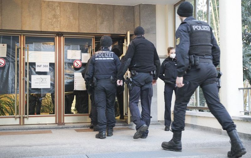 Police enter a building of the University in Heidelberg, southwestern Germany, in which allegedly a man perpetrated an attack on January 24, 2022. - A gunman stormed a lecture hall at Heidelberg University in southwestern Germany, killing a young woman and injuring three others before fleeing the scene and turning the weapon on himself. The man fired shots "wildly" around the amphitheatre, a police spokesman told AFP. He appeared to have no religious or political motive, German media reported. (Photo by Daniel ROLAND / AFP)