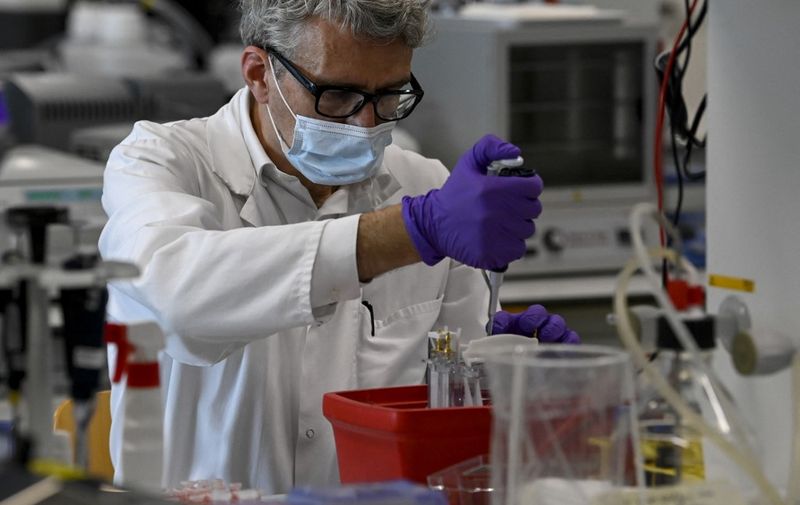 A laboratory analyst is at work at the headquarters of the "Janssen Pharmaceutica" pharmaceutical company in Beerse,on June 17, 2020. (Photo by DIRK WAEM / various sources / AFP) / Belgium OUT