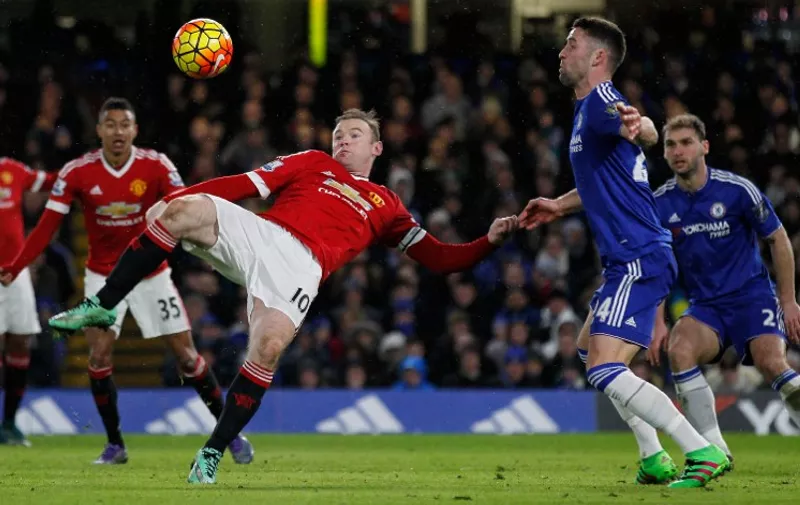 Manchester United's English striker Wayne Rooney (L) has a shot on goal by Chelsea's English defender Gary Cahill during the English Premier League football match between Chelsea and Manchester United at Stamford Bridge in London on February 7, 2016. / AFP / Ian Kington / RESTRICTED TO EDITORIAL USE. No use with unauthorized audio, video, data, fixture lists, club/league logos or 'live' services. Online in-match use limited to 75 images, no video emulation. No use in betting, games or single club/league/player publications.  /