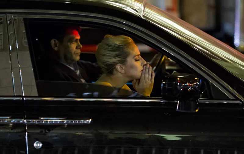 Musician Lady Gaga sits in her car after staging a protest against Republican presidential nominee Donald Trump outside Trump Tower in New York City after midnight on election day November 9, 2016. - Donald Trump stunned America and the world, riding a wave of populist resentment to defeat Hillary Clinton in the race to become the 45th president of the United States.
The Republican mogul defeated his Democratic rival, plunging global markets into turmoil and casting the long-standing global political order, which hinges on Washington's leadership, into doubt. (Photo by DOMINICK REUTER / AFP)