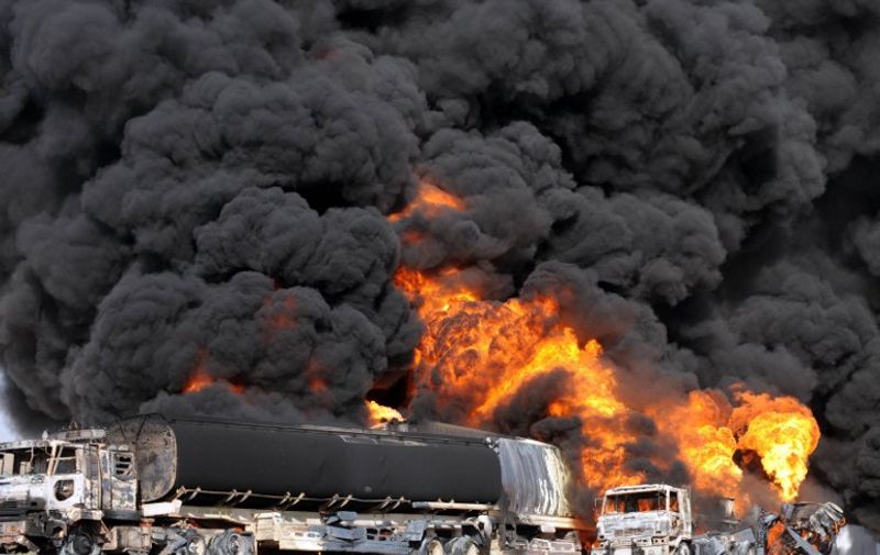 Smoke and flame rise from burning NATO supply trucks after they were attacked by armed militants on the outskirts of Quetta on September 27, 2011. Gunmen in southwestern Pakistan attacked three oil tankers and a container carrying supplies to NATO troops in Afghanistan, officials said. AFP PHOTO / BANARAS KHAN