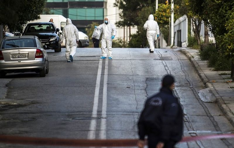 Greek police experts search the area outside the Russian consulate in Athens on March 22, 2019. - A grenade was thrown early on March 22 into the courtyard of the Russian consulate in Athens, an attack typical of domestic far-left groups, according to the police. The area in the Athens suburb of Halandri was rapidly cordoned off and bomb specialists were dispatched, a police source said. (Photo by ANGELOS TZORTZINIS / AFP)