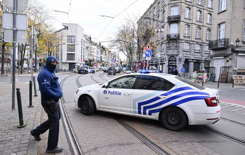 A police car is parked near the house in the Schaerbeek area of Brussels on October 17, 2023, where the suspected perpetrator of the attack in Brussels was shot dead during a police intervention. The suspect in the Brussels killing of two Swedish football fans was shot and fatally wounded by police during his arrest on October 17, 2023 officials said. (Photo by JOHN THYS / AFP)