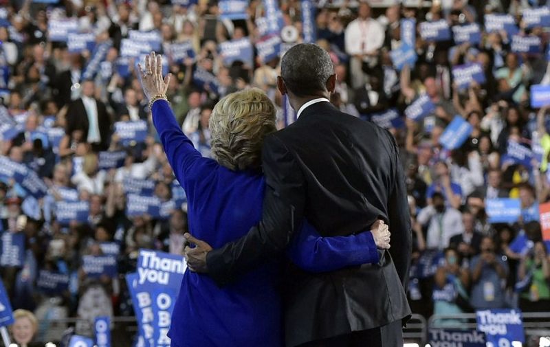 US President Barack Obama is joined by US Democratic presidential candidate Hillary Clinton after his address to the Democratic National Convention at the Wells Fargo Center in Philadelphia, Pennsylvania, July 27, 2016. / AFP PHOTO / MANDEL NGAN