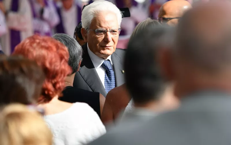 Italy's President Sergio Mattarella meets victims' relatives prior to the mass for the first anniversary of the collapse of the Morandi bridge, on August 14, 2019 in Genoa. - Italy on August 14, 2019 marks a year since the Genoa motorway bridge collapse that killed 43 people, as the country grapples with a political crisis sparked by far-right leader. The ceremony takes place close to the spot where a section of the Morandi highway fell during heavy rain on August 14, 2018, hurling dozens of cars and several trucks onto railway tracks below. (Photo by Alberto PIZZOLI / AFP)
