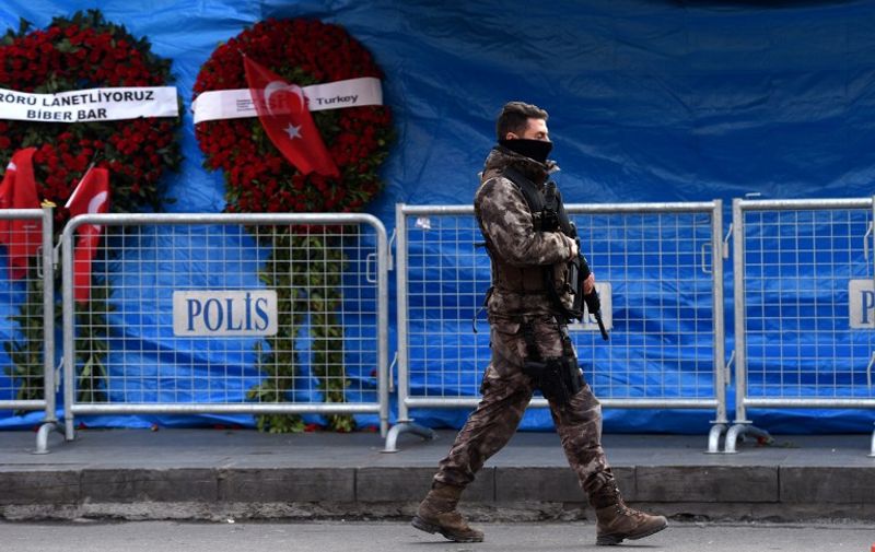 A Turkish special force police officer patrols in front of the Reina nightclub on January 4, 2017 in Istanbul, three days after a gunman killed 39 people on New Year's night.  
The gunman had fought in Syria for Islamic State jihadists, a report said on January 3, as Turkish authorities intensified their hunt for the attacker. Of the 39 dead, 27 were foreigners, mainly from Arab countries, with coffins repatriated overnight to countries including Lebanon and Saudi Arabia. / AFP PHOTO / OZAN KOSE