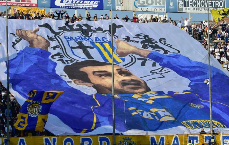 Parma&#8217;s supporter waves a giant flag during the Serie A football match Parma vs Juventus at &#8220;Tardini Stadium&#8221; in Parma on April 11, 2015 . AFP PHOTO /