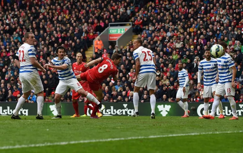 Liverpool's English midfielder Steven Gerrard (C) scores the winning goal during the English Premier League football match between Liverpool and Queens Park Rangers at the Anfield stadium in Liverpool, northwest England, on May 2, 2015.  AFP PHOTO / PAUL ELLIS

RESTRICTED TO EDITORIAL USE. No use with unauthorized audio, video, data, fixture lists, club/league logos or live services. Online in-match use limited to 45 images, no video emulation. No use in betting, games or single club/league/player publications.