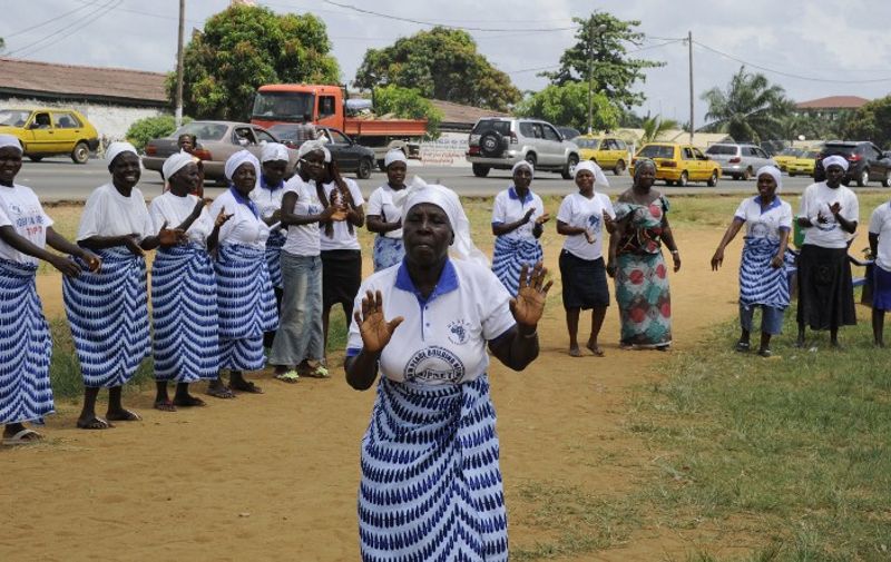 Members of the Women In Peacebuilding Network ( WIPNET) dance, sing and pray on May 8, 2015 in Monrovia. If there are no new infections in the next 48 hours, the World Health Organization (WHO) will declare Liberia "Ebola-free" on May 9, 2015, 42 days -- or twice the incubation period of the virus -- after the last case.  AFP PHOTO / ZOOM DOSSO