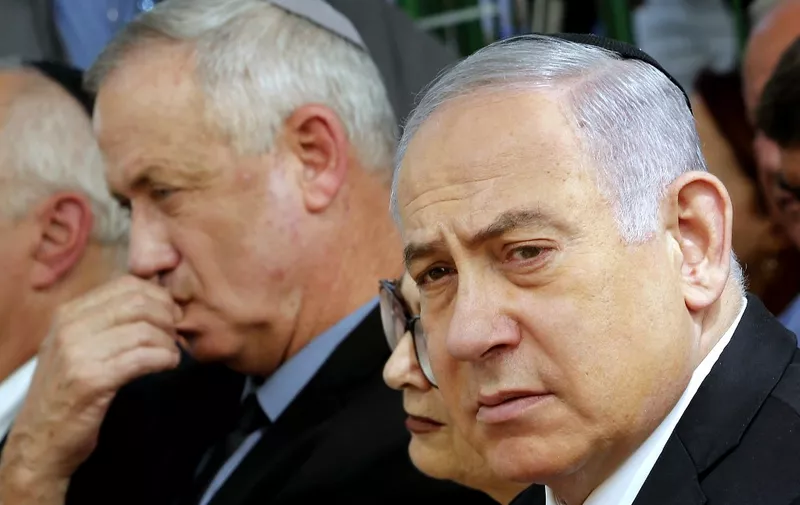 Israeli Prime Minister Benjamin Netanyahu (R), Israeli president of the Supreme Court Esther Hayut (C) and Benny Gantz (L), leader of Blue and White party, attend a memorial ceremony for late Israeli president Shimon Peres, at Mount Herzl in Jerusalem on September 19, 2019. Netanyahu called on his main challenger Benny Gantz to form a unity government together, a major development after deadlocked election results put his long tenure in office at risk. (Photo by GIL COHEN-MAGEN / AFP)