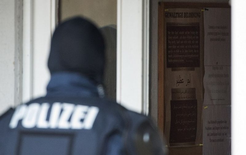 A police officer stands at the antrance of a building of the Mesdschid Sahabe Islamic cultural and educational center during a raid in Stuttgart, southern Germany, on December 17, 2015.
German authorities raided, shuttered and banned the Muslim association and mosque they accused of supporting the Islamic State jihadist group in Syria and Iraq. Police in the southwestern city of Stuttgart confiscated computers, data storage devices, smartphones and documents, said the interior minister of Baden-Wurttemberg state, without reporting any arrests.
 / AFP / dpa / - / Germany OUT