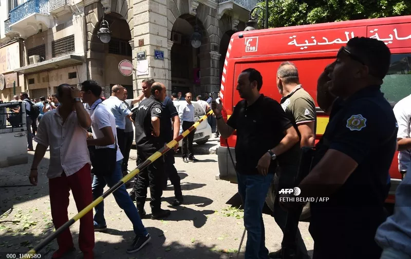 Tunisian security forces cordon off the site of an attack in the Tunisian capital's main avenue Habib Bourguiba on June 27, 2019. - Two suicide bombers attacked police and the national guard in the Tunisian capital, killing a police officer and wounding at least eight people including several civilians, the interior ministry said. One attack on the main street of Tunis wounded three civilians and two police personnel, the interior ministry said. (Photo by FETHI BELAID / AFP)