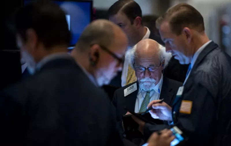 Traders work after the closing bell at the New York Stock Exchange (NYSE) on Wall Street in New York City on May 23, 2019. (Photo by Johannes EISELE / AFP)