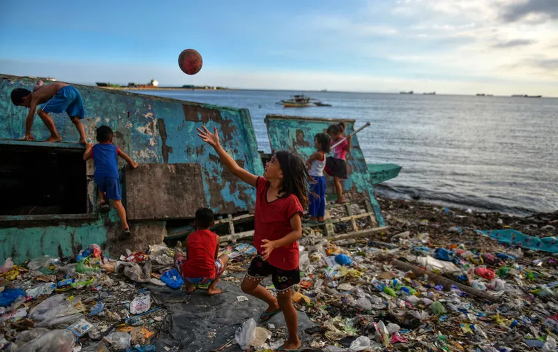 MANILA, PHILIPPINES - APRIL 14: Children playing on a beach filled with plastic wastes on April 14, 2018 in Manila, Philippines. The Philippines has been ranked third on the list of the world's top-five plastic polluter into the ocean, after China and Indonesia, while reports show that almost half of the global plastic garbage come from developing countries, including Vietnam and Thailand. Sunday marks the 48th iteration of Earth Day, an annual event marked across the world to show support for environmental protection, as organizations aim to dedicate this year's theme towards ending plastic pollution and change people's attitudes and behavior about plastic consumption and the impact it has on the environment. Over a million people have reportedly signed petitions around the world, demanding for corporations to reduce the production of single-use plastics which affects rapidly developing countries as most disposable packaging like food-wrapping, sachets, and shopping bags land up on the coastlines after being discarded. Most of these countries lack the infrastructure to effectively manage their waste and those who live on lower incomes usually rely on cheap products which are sold in single-use sachets such as instant coffee, shampoo, and food seasoning. According to studies, there could be more plastic in the sea than fish by 2050 while actual plastic bits might be in our seafood as fishes consume bits of plastic which are coated in bacteria and algae, mimicking their natural food sources, and eventually lands on our dinner table. (Photo by Jes Aznar/Getty Images)