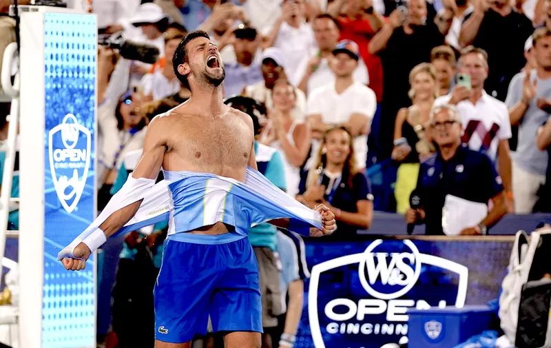 Aug 20, 2023; Mason, OH, USA; Novak Djokovic, of Serbia, rips his shirt in celebration after defeating Carlos Alcaraz, of Spain, at the conclusion of the men’s singles final of the Western &amp; Southern Open tennis tournament at Lindner Family Tennis Center. Mandatory Credit: Kareem Elgazzar/The Enquirer-USA TODAY Sports