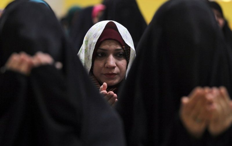Iraqi Shiite women perform Eid al-Adha prayers at the headquarters of the Shiite Muslim Supreme Iraqi Islamic Council (SIIC) in Baghdad, on September 24, 2015. Eid al-Adha (the Festival of Sacrifice) is celebrated throughout the Muslim world as a commemoration of Abraham's willingness to sacrifice his son for God, and cows, camels, goats and sheep are traditionally slaughtered on the holiest day.  AFP PHOTO/ AHMAD AL-RUBAYE