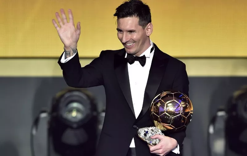 FC Barcelona and Argentina's forward Lionel Messi waves holding his trophy after receiving the 2015 FIFA Ballon dOr award for player of the year during the 2015 FIFA Ballon d'Or award ceremony at the Kongresshaus in Zurich on January 11, 2016. AFP PHOTO / FABRICE COFFRINI / AFP / FABRICE COFFRINI