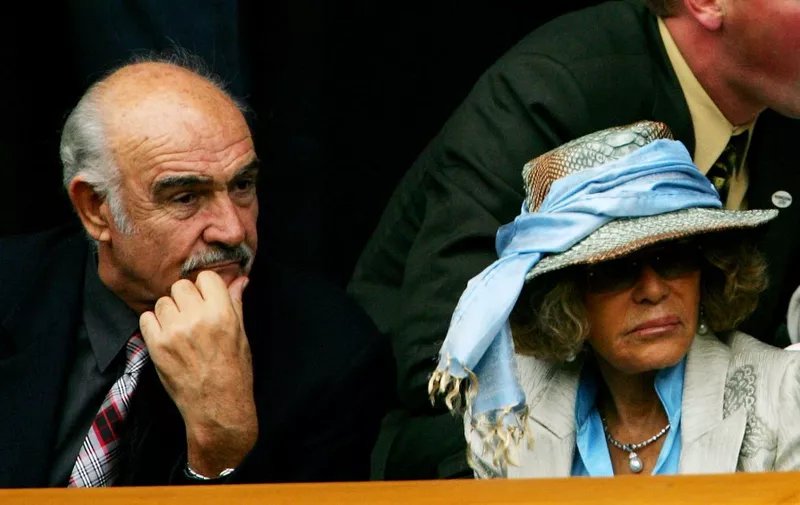 Scottish actor Sean Connery and his wife Micheline sit in the Royal Box on Centre Court at the 119th Wimbledon Tennis Championships in London, 25 June, 2005.  AFP PHOTO/ADRIAN DENNIS (Photo by ADRIAN DENNIS / AFP)