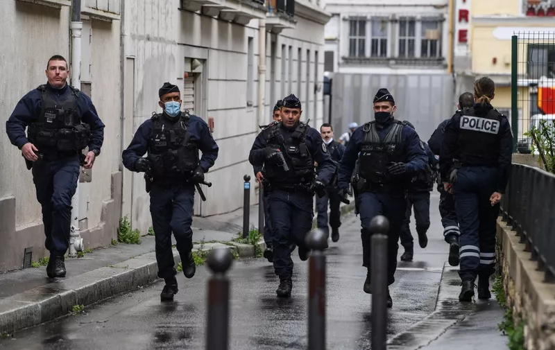 French police officers rush to the scene after people were injured near the former offices of the French satirical magazine Charlie Hebdo following an alleged attack by a man wielding a knife in the capital Paris on September 25, 2020. - A man armed with a knife seriously wounded two people on September 25, 2020, in a suspected terror attack outside the former offices of French satirical weekly Charlie Hebdo in Paris, three weeks into the trial of men accused of being accomplices in the 2015 massacre of the newspaper's staff. Charlie Hebdo had angered many Muslims around the world by publishing cartoons of the Prophet Mohammed, and in a defiant gesture ahead of the trial this month, it reprinted the caricatures on its front cover. (Photo by Alain JOCARD / AFP)