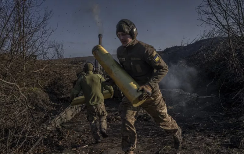 Ukrainian soldiers of an artillery unit fire towards Russian positions outside Bakhmut on November 8, 2022, amid the Russian invasion of Ukraine. (Photo by BULENT KILIC / AFP)
