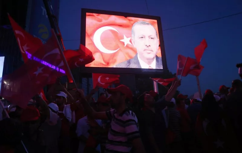 An image of Turkey's President Recep Tayyip Erdogan is displayed on a screen as supporters gather at Kizilay square in Ankara on July 17, 2016 during a demonstration in support to the Turkish government following a failed coup attempt. 

Turkish authorities pressed on July 17 with a ruthless crackdown against suspects in the failed coup against President Recep Tayyip Erdogan, with 6,000 people detained as he vowed to stamp out the "virus" of the putschists. Erdogan also said Turkey could consider reinstating the death penalty following the putsch bid, despite concerns in the international community.
 / AFP PHOTO / ADEM ALTAN