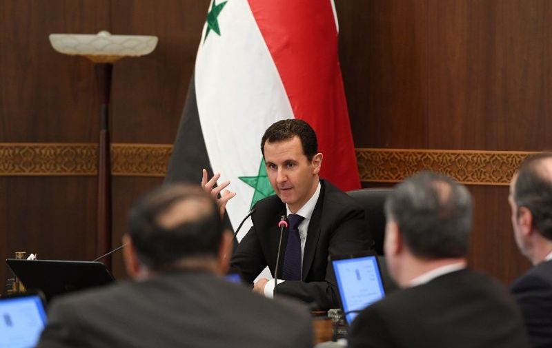 A handout picture released by the official Syrian Arab News Agency (SANA) shows Syrian President Bashar al-Assad attending a cabinet meeting during which he launched administrative reforms, on June 20, 2017, in the capital Damascus. / AFP PHOTO / SANA / HO / RESTRICTED TO EDITORIAL USE - MANDATORY CREDIT "AFP PHOTO / HO / SANA" - NO MARKETING NO ADVERTISING CAMPAIGNS - DISTRIBUTED AS A SERVICE TO CLIENTS