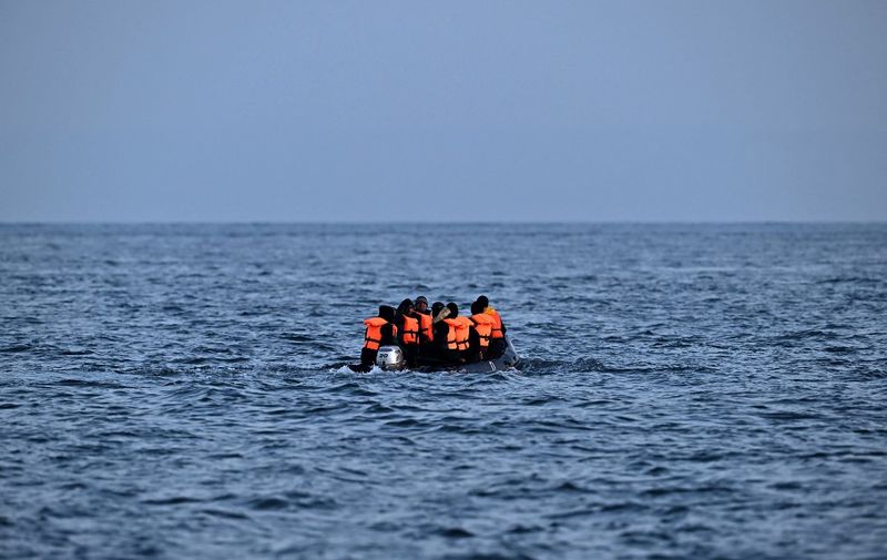 Migrants travel in an inflatable boat across the English Channel, bound for Dover on the south coast of England. - More than 45,000 migrants arrived in the UK last year by crossing the English Channel on small boats. (Photo by Ben Stansall / AFP)