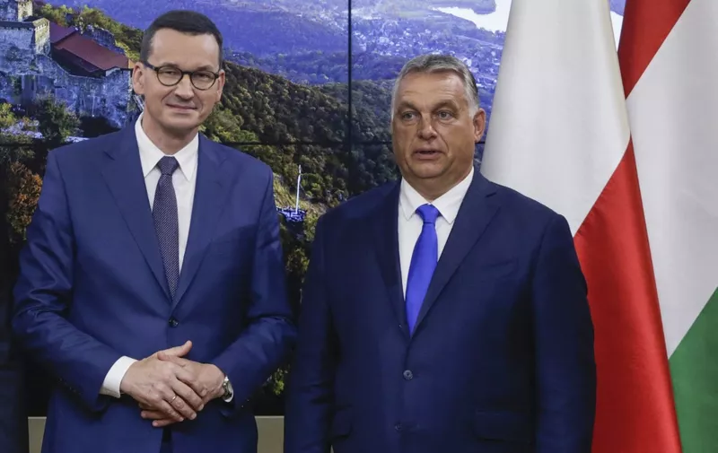 (FILES) This file photo taken on September 24, 2020 shows Polish Prime Minister Mateusz Morawiecki (L) and Hungarian Prime Minister Viktor Orban posing ahead of a press conference at the Polish Permanent representation in Brussels. - The EU's top court on February 16, 2022 rejected a challenge by Poland and Hungary to a mechanism allowing Brussels to slash funding to member states that flout democratic standards. The judgment exposes Poland and Hungary -- seen as democratic backsliders in the 27-nation bloc -- to the risk of seeing money cut from the billions in EU funding they receive. The two countries responded immediately with fury. Both are expected to mount further legal battles against it. (Photo by Aris Oikonomou / AFP) / ALTERNATIVE CROP