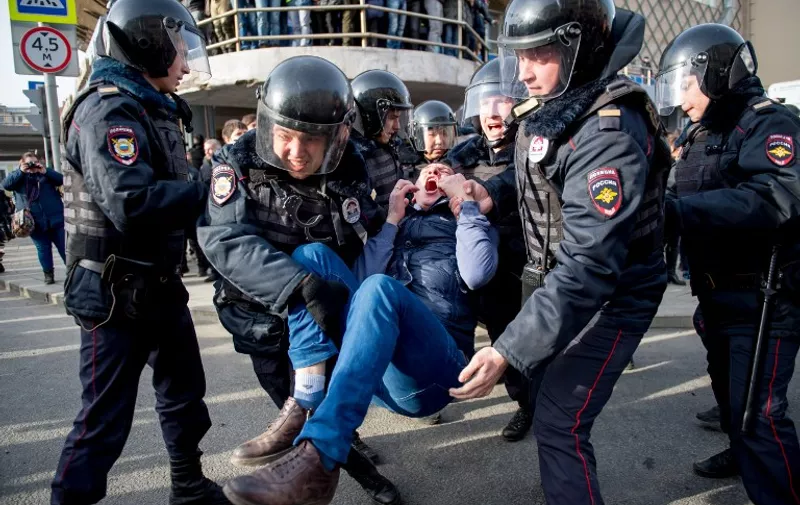 Riot police officers detain a protester during an unauthorised anti-corruption rally in central Moscow on March 26, 2017.
Thousands of Russians demonstrated across the country on March 26 to protest at corruption, defying bans on rallies which were called by prominent Kremlin critic Alexei Navalny -- who was arrested along with scores of others. Navalny called for the protests after publishing a detailed report this month accusing Prime Minister Dmitry Medvedev of controlling a property empire through a shadowy network of non-profit organisations. 
 / AFP PHOTO / Alexander UTKIN