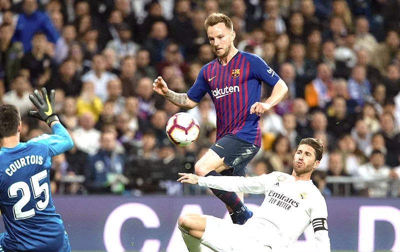 Ivan Rakitic of FC Barcelona and Sergio Ramos and Thibaut Courtois of Real Madrid during the match between Real Madrid vs FC Barcelona of La Liga, date 26, 2018-2019 season. Santiago Bernabeu Stadium, Madrid, Spain &#8211; 2 MAR 2019., Image: 416927618, License: Rights-managed, Restrictions: *** World Rights Except Japan, Spain, and The Netherlands ***, Model [&hellip;]