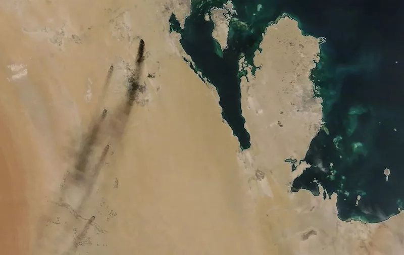 A satellite image provided by NASA Worldview on September 14, 2019, shows fires following drone strikes on two major oil installation owned by the state giant Aramco, in eastern Saudi Arabia, and claimed by the Tehran-backed Huthi rebels in neighbouring Yemen, where a Saudi-led coalition is bogged down in a five-year war. - Saudi Arabia raced on September 15, 2019 to restart operations at oil plants hit by drone attacks which slashed its production by half, as Iran dismissed US claims it was behind the assault. The peninsula in the image is Qatar and the island (top) is Bahrain. (Photo by Handout / NASA Worldview / AFP) / RESTRICTED TO EDITORIAL USE - MANDATORY CREDIT "AFP PHOTO / NASA Worldview " - NO MARKETING - NO ADVERTISING CAMPAIGNS - DISTRIBUTED AS A SERVICE TO CLIENTS