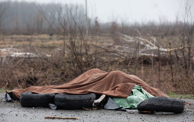 April 2, 2022, Bucha, Ukraine: (EDITORS NOTE: Image depicts death) Four dead civilians are seen on the sidelines of the highway under a blanket at 20km from Kyiv. Almost 300 civilians have been killed along the road in between Zhytomyr and Kyiv near Bucha as most victims tried to cross the Buchanka river to reach the Ukrainian controlled territory and had been killed. Russia invaded Ukraine on 24 February 2022, triggering the largest military attack in Europe since World War II.,Image: 677188898, License: Rights-managed, Restrictions: , Model Release: no, Credit line: Profimedia