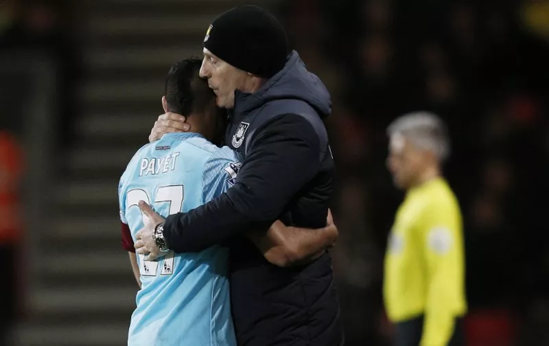 West Ham United's French midfielder Dimitri Payet (L) is embraced by West Ham United's Croatian manager Slaven Bilic during the English Premier League football match between Bournemouth and West Ham United at the Vitality Stadium in Bournemouth, southern England on January 12, 2016. AFP PHOTO / ADRIAN DENNIS

RESTRICTED TO EDITORIAL USE. No use with unauthorized audio, video, data, fixture lists, club/league logos or 'live' services. Online in-match use limited to 75 images, no video emulation. No use in betting, games or single club/league/player publications. / AFP / ADRIAN DENNIS