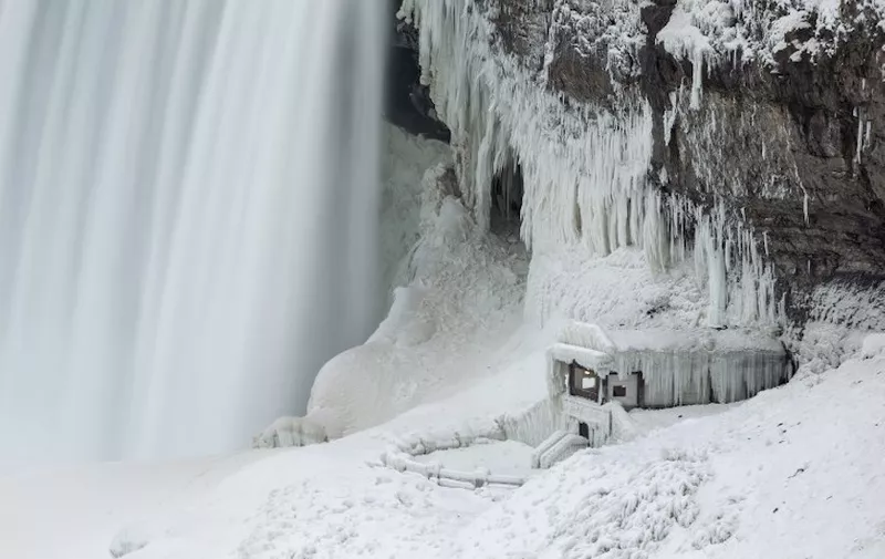 An observation point at the base of Niagara Falls is covered with ice, in Niagara Falls, Ontario is covered in ice, January 9, 2018. - A giant winter "bomb cyclone" walloped the US East Coast on January 5, 2018, with heavy snow and freezing cold that made for treacherous travel conditions and bone-chilling misery. (Photo by Geoff Robins / AFP)