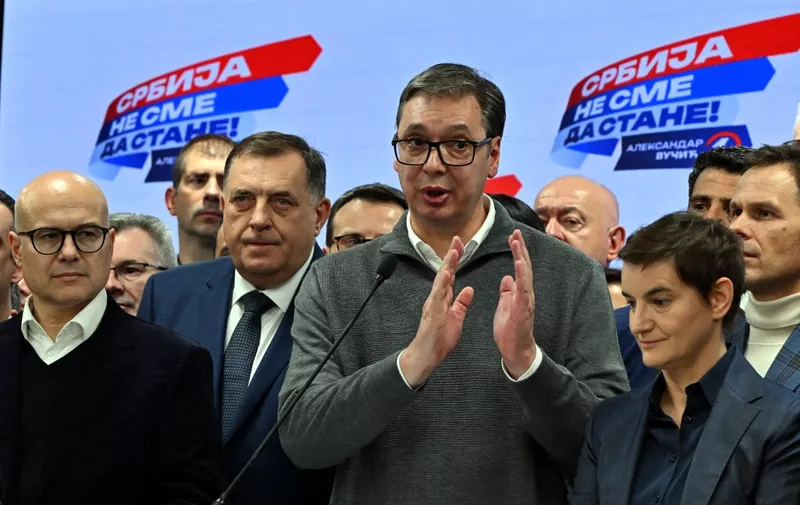 Serbian president, Aleksandar Vucic (C), addresses the media at the headquarters of Srpska Napredna Stranka (Serbian Progressive Party) in Belgrade, late on December 17, 2023. Vucic and his party claimed victory, upon closing of polling stations nation wide, on Parliamentary election day. Serbians awaited the results after voting in elections on Sunday that will likely see President Aleksandar Vucic's populist party extend its rule, with the strongman leader promising stability and vowing to curb inflation after months of protests.  Even though Vucic is not personally on the ballot in Sunday's parliamentary and local elections, the contest has largely been seen as a referendum on his government. (Photo by ELVIS BARUKCIC / AFP)
