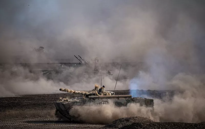 Russian army tanks and armored personnel carriers take part in military exercises at the Prudboy range in Volgograd region, Southern Russia on September 24, 2020 during the "Caucasus-2020" military drills gathering China, Iran, Pakistan and Myanmar troops, along with ex-Soviet Armenia, Azerbaijan and Belarus. - Up to 250 tanks and around 450 infantry combat vehicles and armoured personnel carriers will take part in the September 21 to 26 land and naval exercises that will involve 80,000 people including support staff. (Photo by Dimitar DILKOFF / AFP)