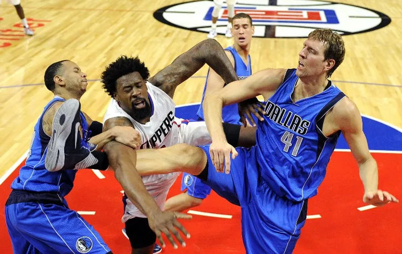 LOS ANGELES CA - OCTOBER 29: DeAndre Jordan #6 of the Los Angeles Clippers is fouled by Dirk Nowitzki #41 and Devin Harris of the Dallas Mavericks during the second quarter of the basketball game Staples Center October 29, 2015, in Los Angeles California. NOTE TO USER: User expressly acknowledges and agrees that, by downloading and or using this photograph, User is consenting to the terms and conditions of the Getty Images License Agreement. Nowitzki and Jordan received technical fouls.   Kevork Djansezian/Getty Images/AFP