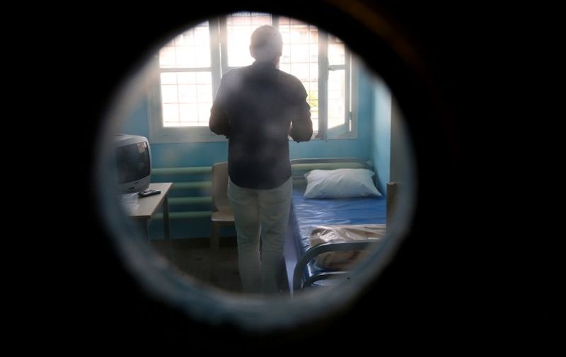 An inmate stands in his cell at Clairvaux Prison in Ville-sous-la-Ferte, northwestern France, on August 4, 2015. AFP PHOTO / FRANCOIS NASCIMBENI / AFP PHOTO / FRANCOIS NASCIMBENI