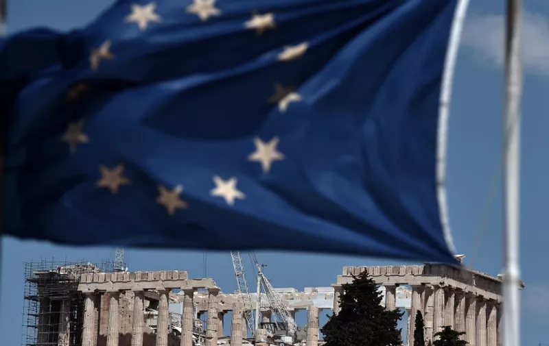 An EU flag waves above the ancient temple of Parthenon atop the Acropolis hill in Athens on July 7, 2015. Eurozone leaders will hold an emergency summit in Brussels on July 7 to discuss the fallout from Greek voters' defiant "No" to further austerity measures, with the country's Prime Minister Alexis Tsipras set to unveil new proposals for talks.. AFP PHOTO /ARIS MESSINIS