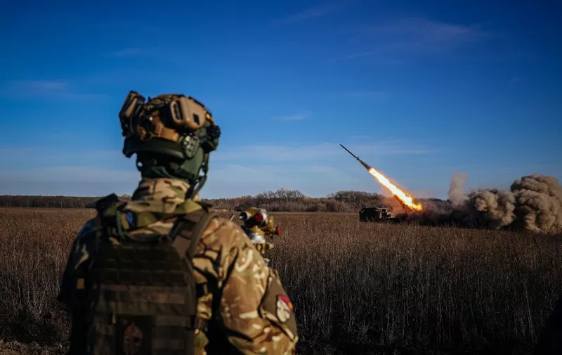 A Ukrainian soldier watches a self-propelled 220 mm multiple rocket launcher "Bureviy" firing towards Russian positions on the front line, eastern Ukraine on November 29, 2022, amid the Russian invasion of Ukraine. (Photo by ANATOLII STEPANOV / AFP)