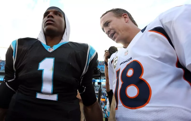 CHARLOTTE, NC - NOVEMBER 11: Cam Newton #1 of the Carolina Panthers talks to Peyton Manning #18 of the Denver Broncos after their game at Bank of America Stadium on November 11, 2012 in Charlotte, North Carolina.   Streeter Lecka/Getty Images/AFP